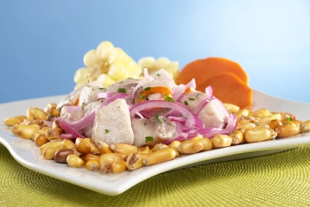 Imagen del ceviche peruano acompañado de choclo, cancha y camote