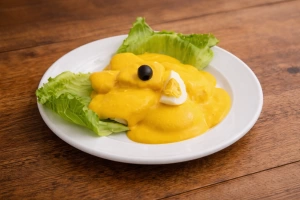 Deliciosa papa a la huancaína con salsa cremosa, huevo duro y aceituna negra